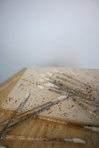 Wooden block with disposable lip wands on a light grey background