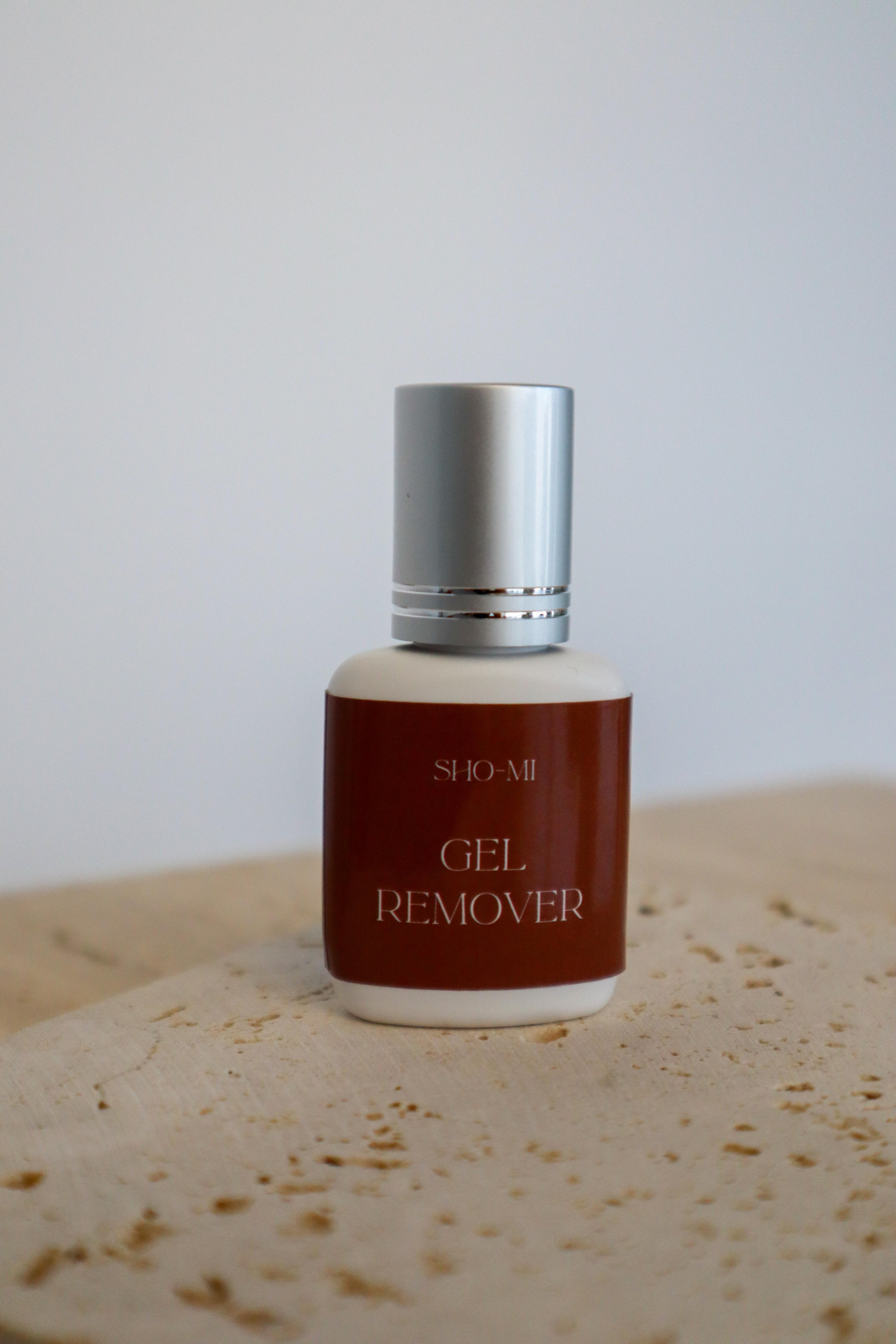 Bottle of SHO-MI Gel Remover on a textured surface with a neutral background