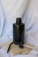 Black bottle with a pump on a white background