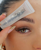 Person holding SHO-MI eyebrow gel to their eyebrow