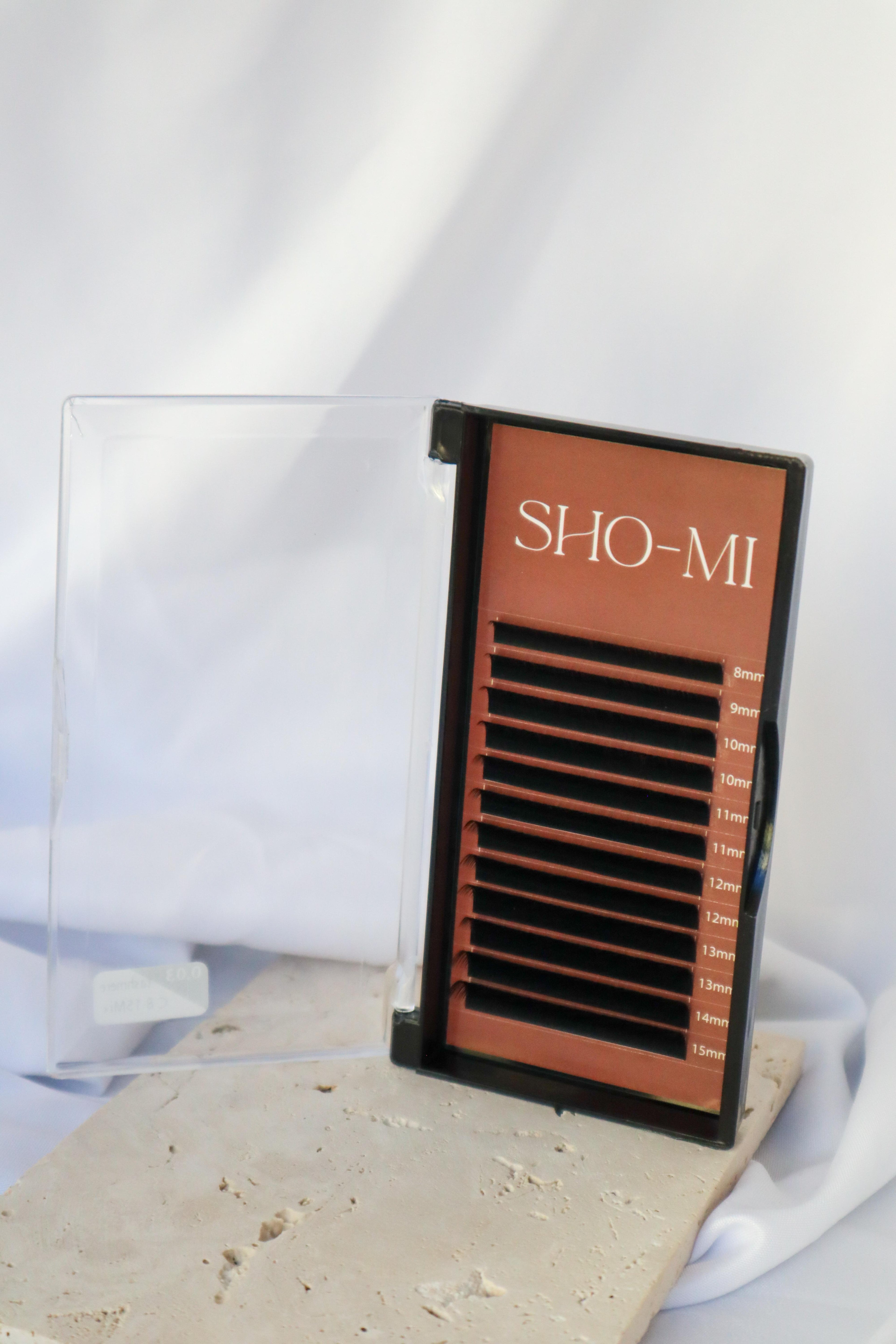 Eyelash extension tray with 'SHO-MI' branding on a white background