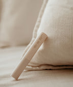 Beige lash and brow growth serum tube on a soft beige background