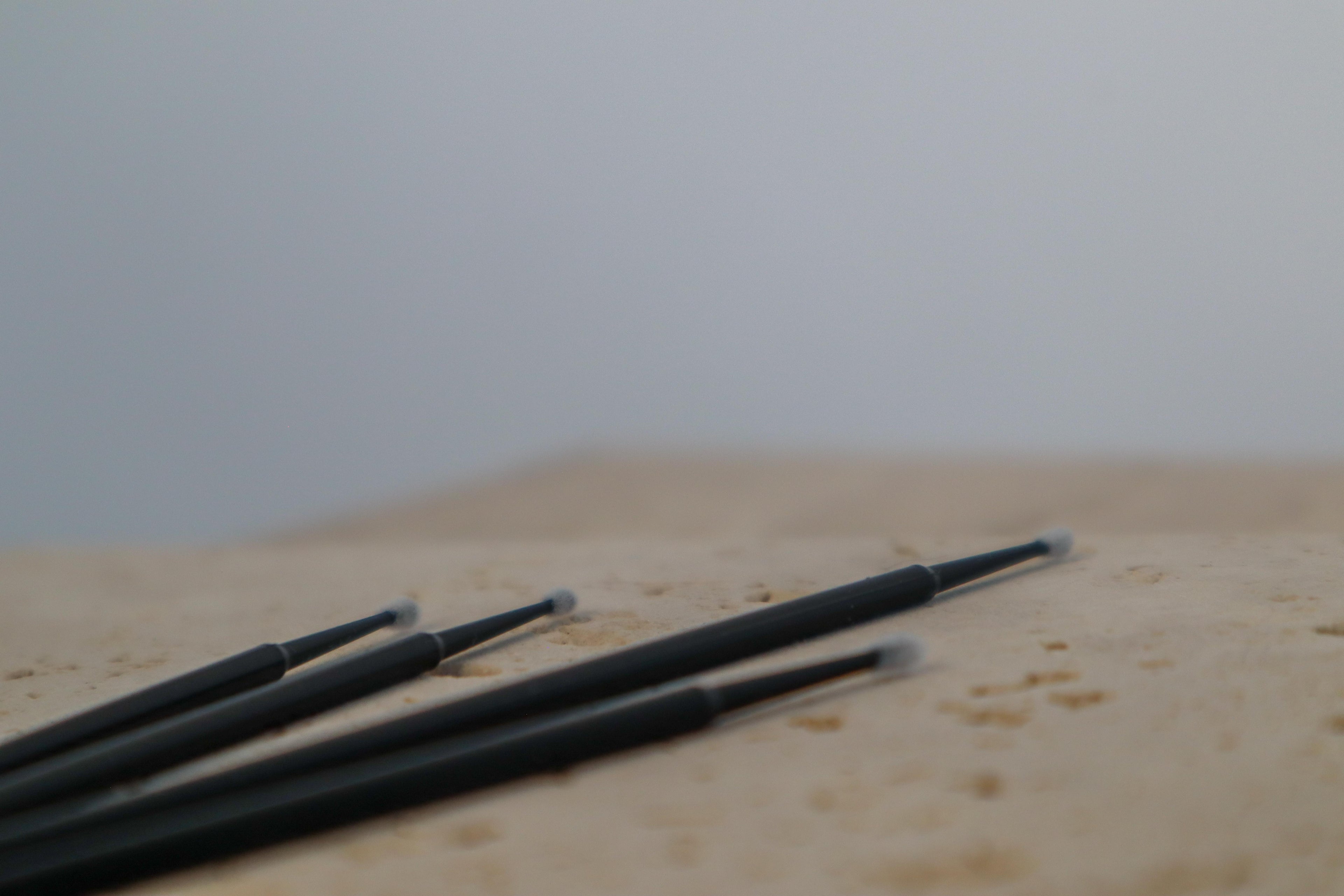 Short tip micro brushes on a beige surface with a blurred background