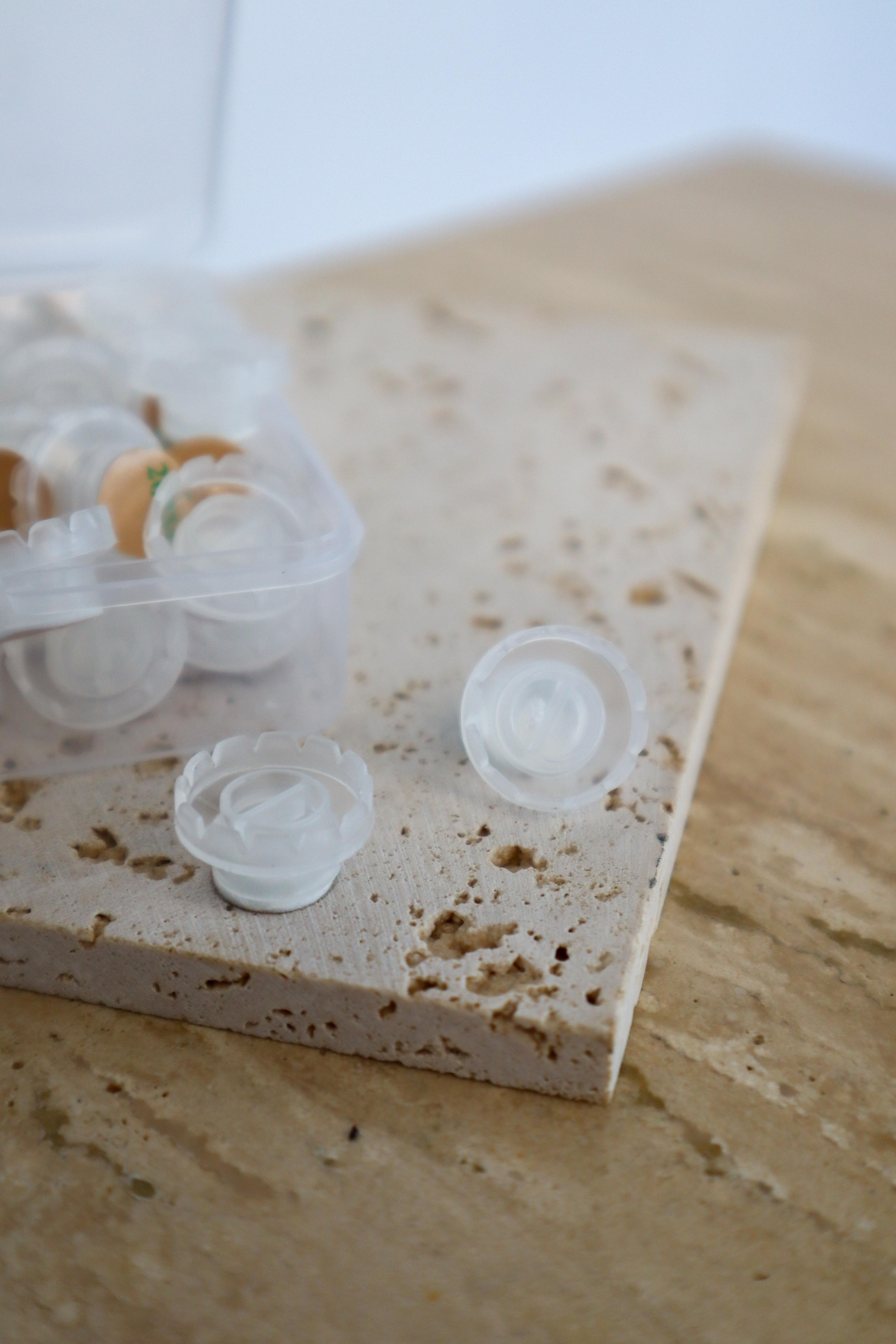 Clear self-adhesive glue cups on a textured surface